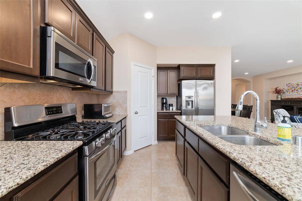Island kitchen open to the breakfast, living, and dining room.
