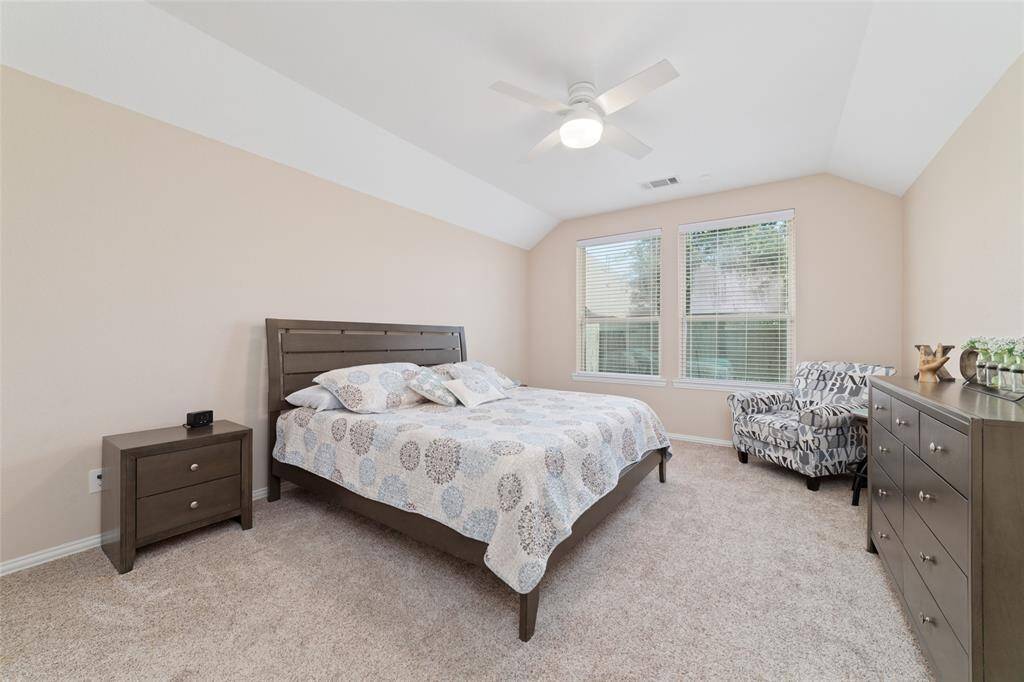 Primary bedroom suite with double sinks, soaking tub, separate shower, and large walk-in closet.