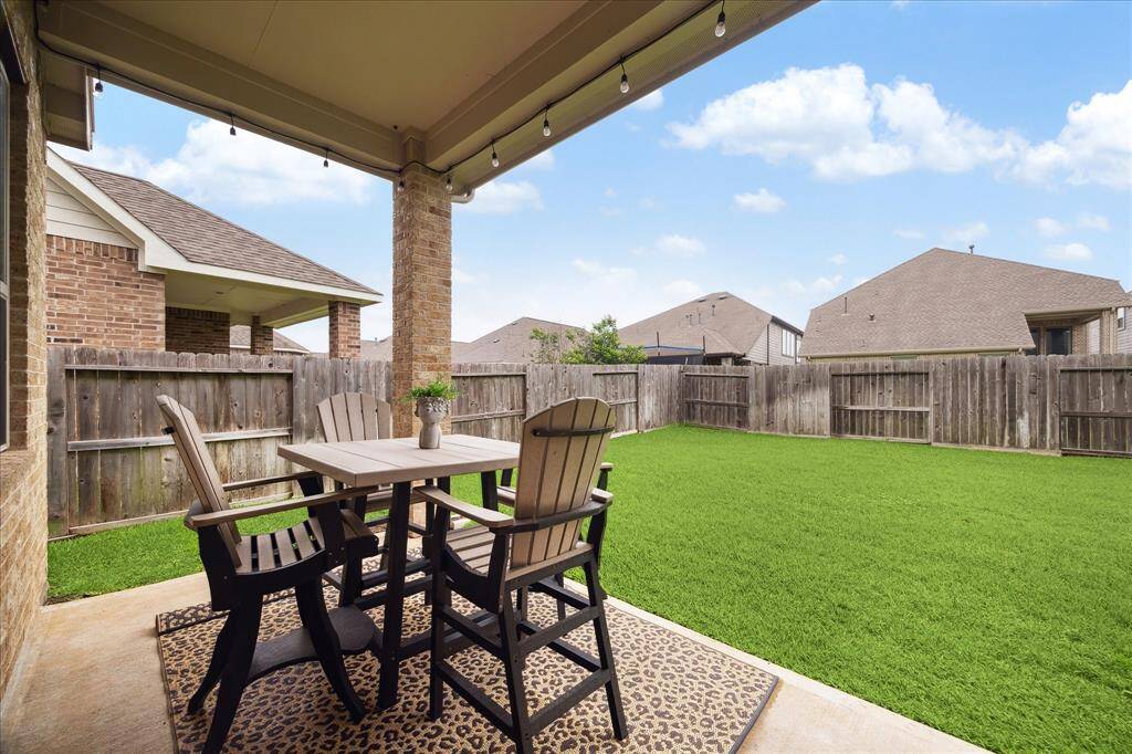Enjoy summer parties with in this spacious backyard with a covered patio. The area is fenced for privacy, and the lawn is well-maintained, offering a perfect space for relaxation or entertaining.