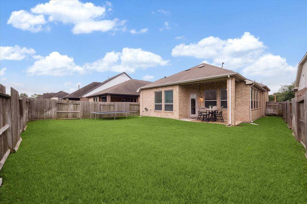 Spacious backyard with grassy lawn for lots of outdoor play!