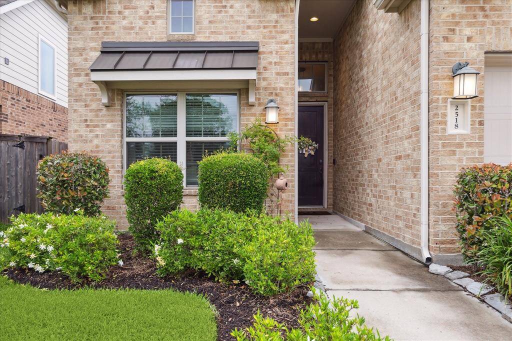 Charming brick exterior with a welcoming front entryway, featuring well-maintained landscaping and a cozy porch. Ideal for a warm and inviting first impression.