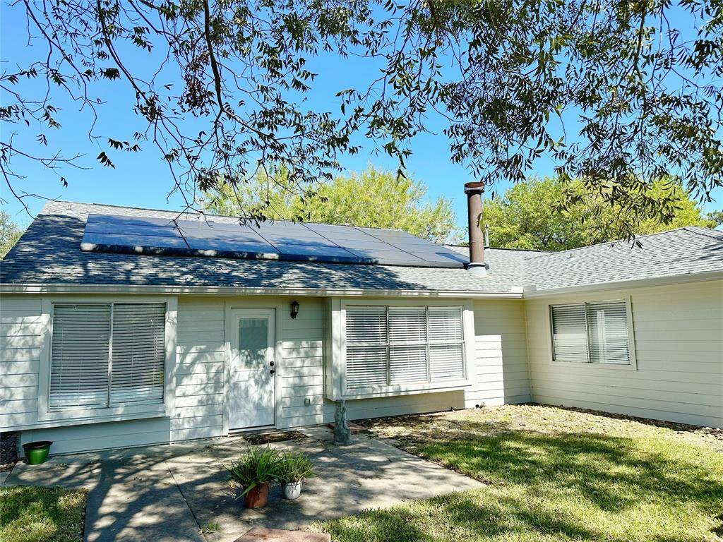 Backyard with tree shade.
