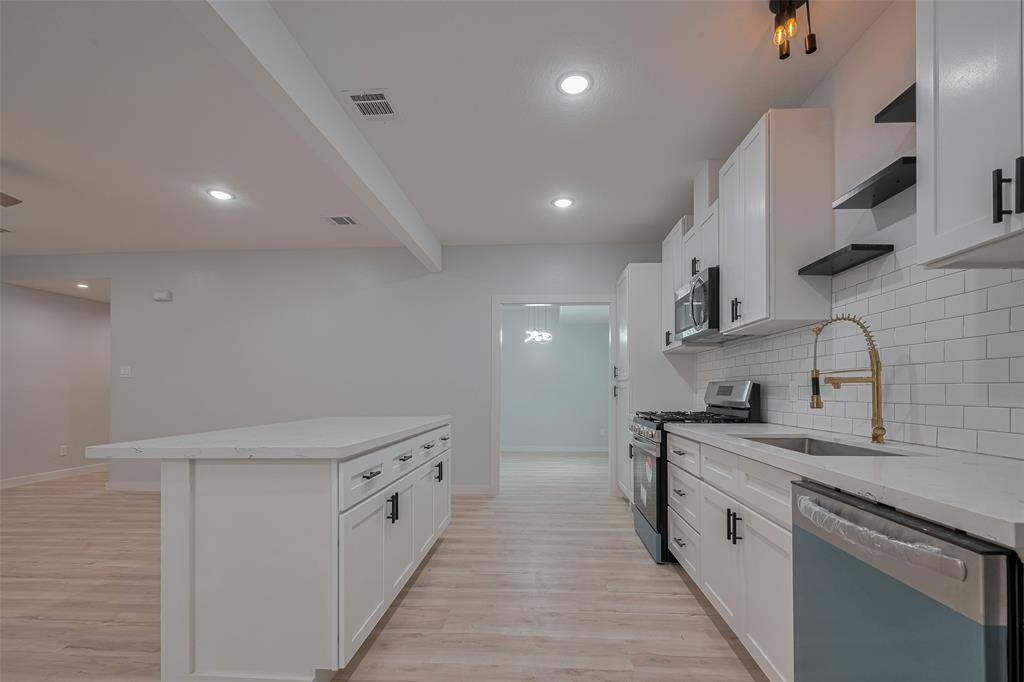 Massive Island. Kitchen leads to the formal dining area.