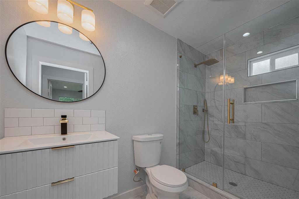 Wall hanging modern vanities in the secondary bathroom.