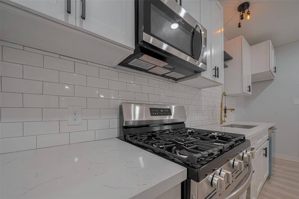Huge white cabinets and stainless steel appliances.