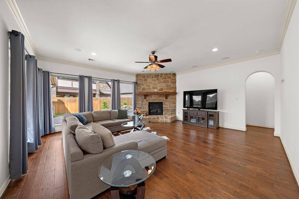 The spacious living rooms offers a great view to the outdoor living room and pool. The fireplace ground the room and is a great focal point.
