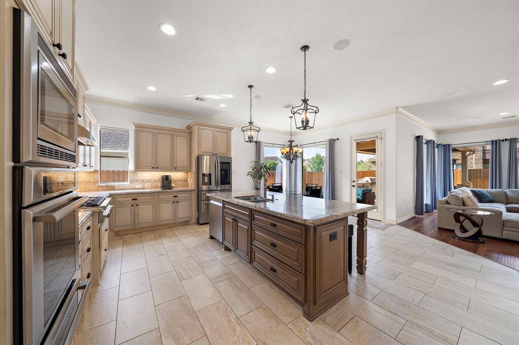Two toned custom cabinetry showcase great counter space and natural light flows in through the kitchen window; great for airing out the house after cooking.