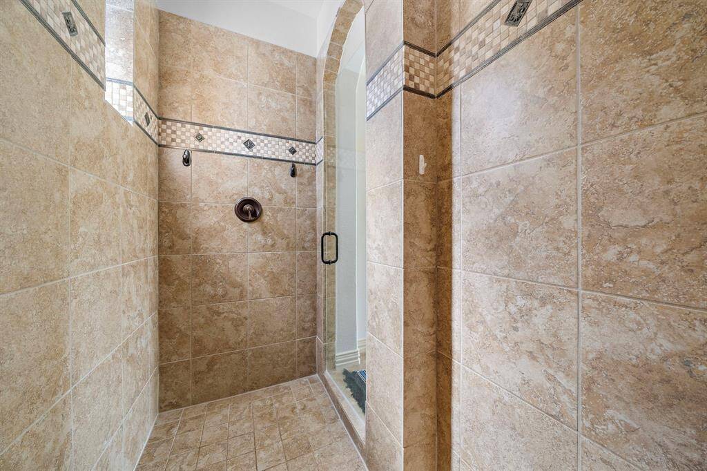 The shower wraps around and is spacious with a window for added natural light.