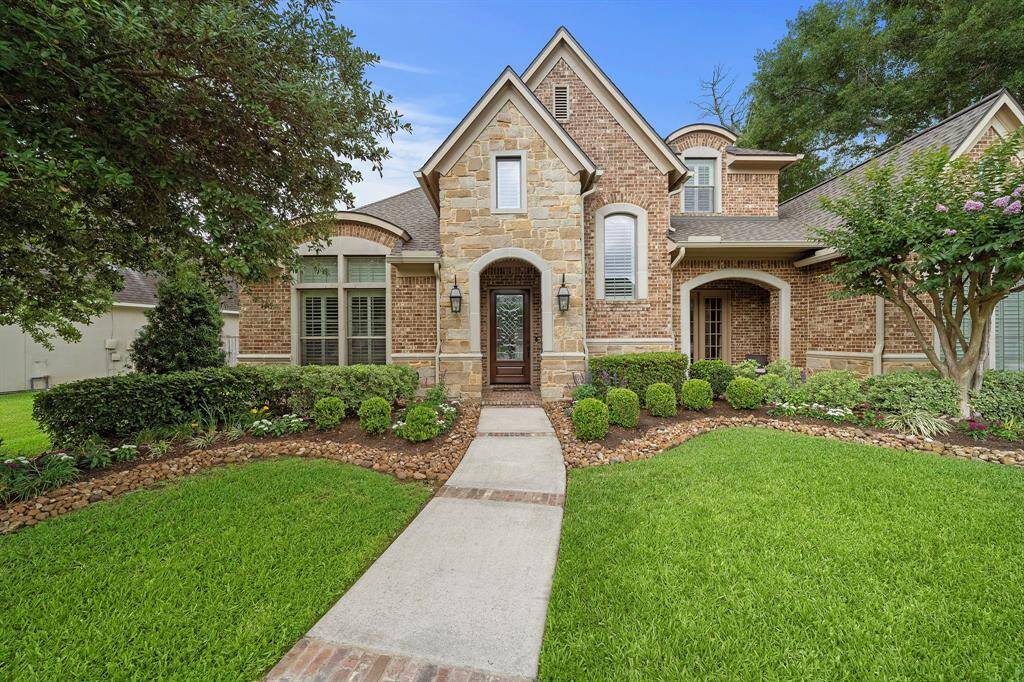 Front entry with brick inlaid in the walkway welcome you home. Work from home? The office offers a literal breath of fresh air with the French doors and covered patio area.