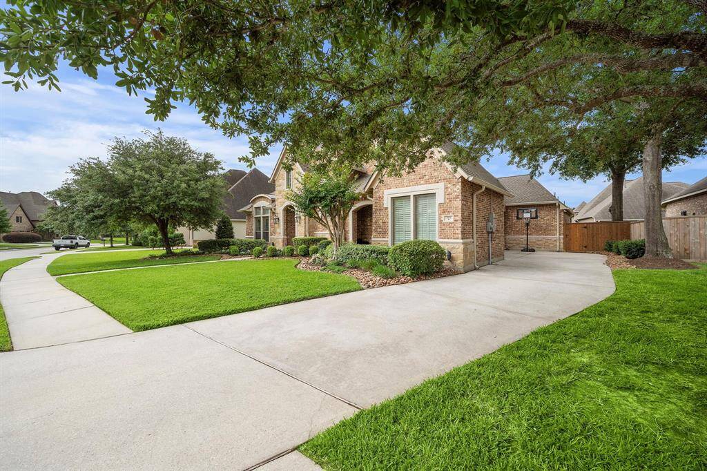The three car garage boasts ample space for cars, hobbyists, and storage.