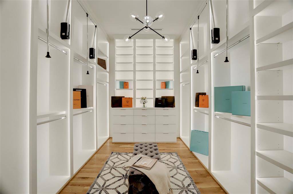 The primary closet is something out of a high-end retail store display. It's so big we couldn't even photograph it all at once but you get the idea. LED display lights can be turned off for everyday use or turned on to impress your guests.