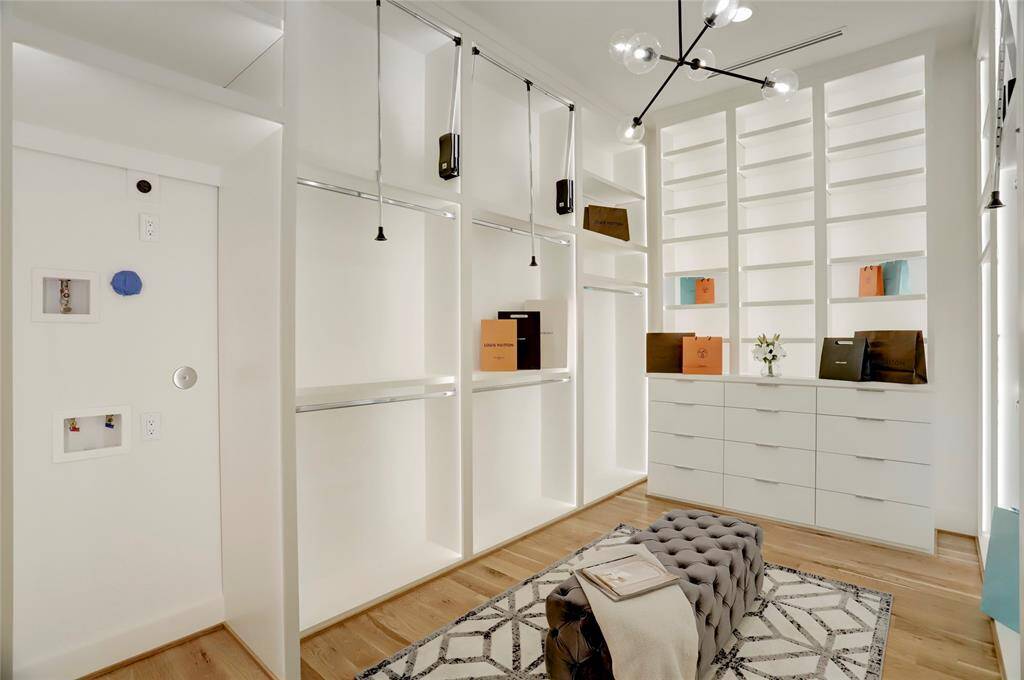The primary closet also includes a built-in space for a stackable washer and gas or electric dryer for added comfort.