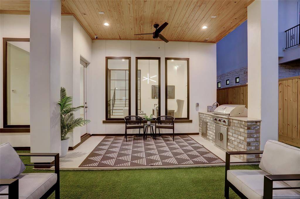 Situated off the living room, primary suite, and study is the outdoor kitchen lanai and artificial turf courtyard space.
