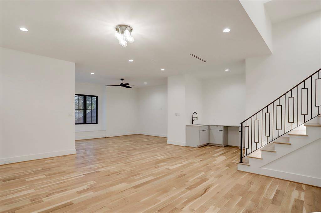 Another angle of the second-floor game room and media room showcasing the wet bar area.