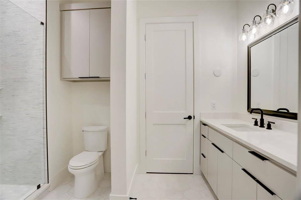 The main utility room is located between the second floor bedrooms and offers plenty of cabinet and counter space with a sink.