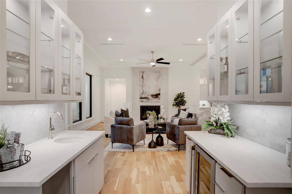 Sitting between the living and dining rooms is the wet bar/butler's pantry with a beverage fridge, space/plumbing for an ice maker, and glass-front cabinets.