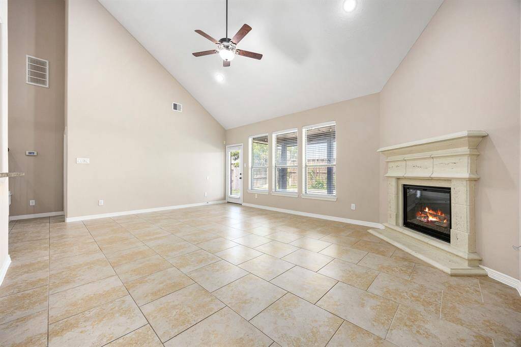 The living room offers direct access to the backyard and covered patio. This carpet-free home features easy-to-maintain flooring throughout.