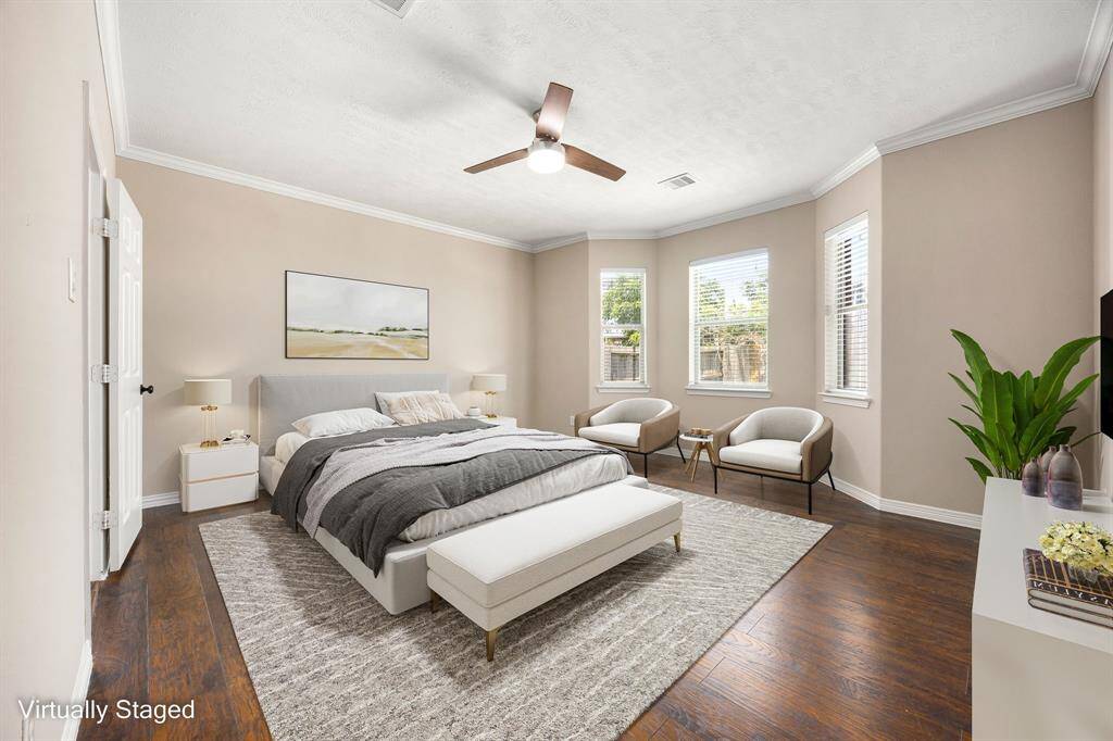 This virtually-staged primary bedroom shows just how cozy and inviting this space can be—easy to imagine yourself unwinding here.