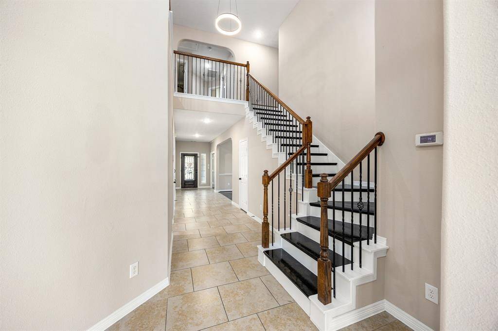 Stairway has been upgraded and has wood steps leading to 3 secondary bedrooms, a game room, a flex room and 2 bathrooms.