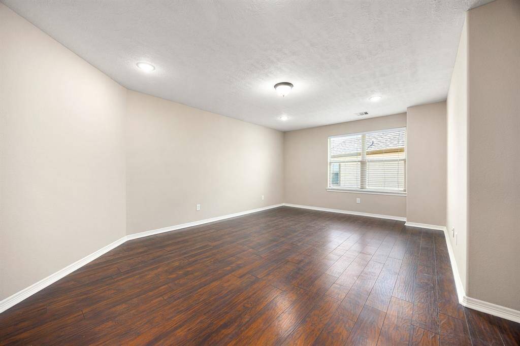 Game room is located upstairs and features vinyl wood-look plank flooring.