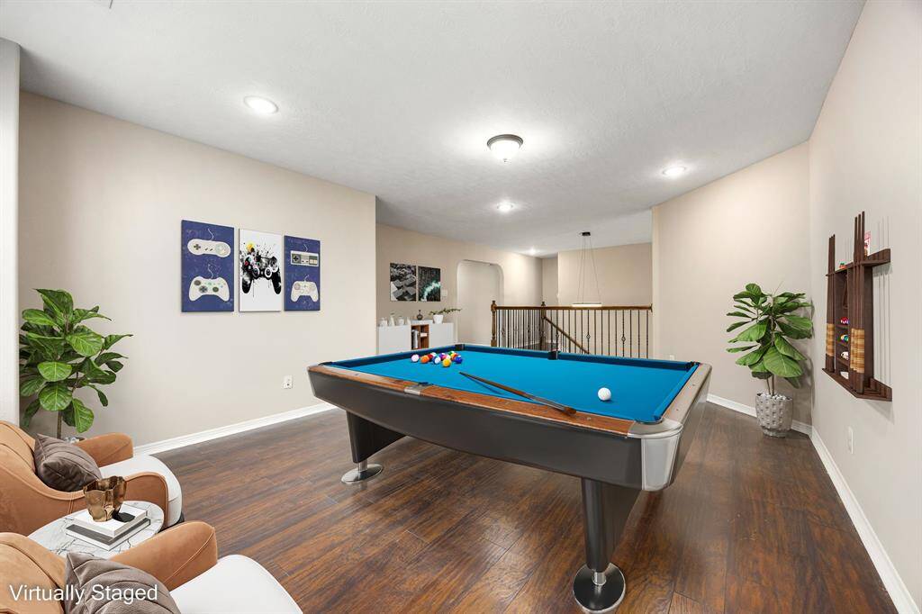 This spacious second-floor game room is virtually staged to spark ideas—perfect for play, movie nights, or your next hangout spot.