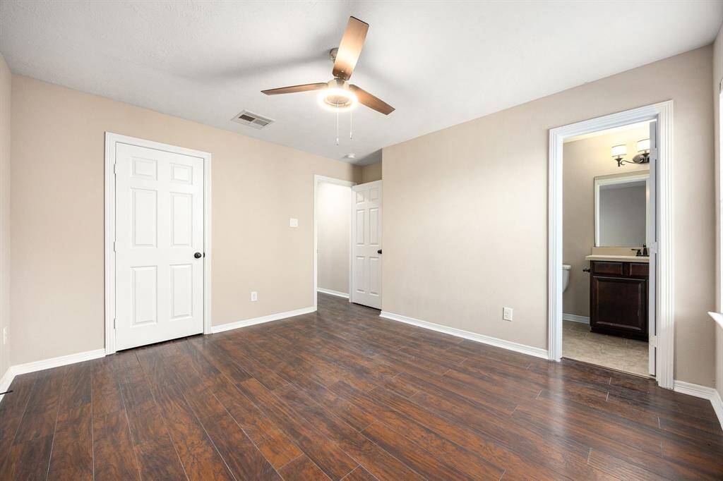 Secondary bedroom upstairs featuring an en-suite bathroom and large walk-in closet.