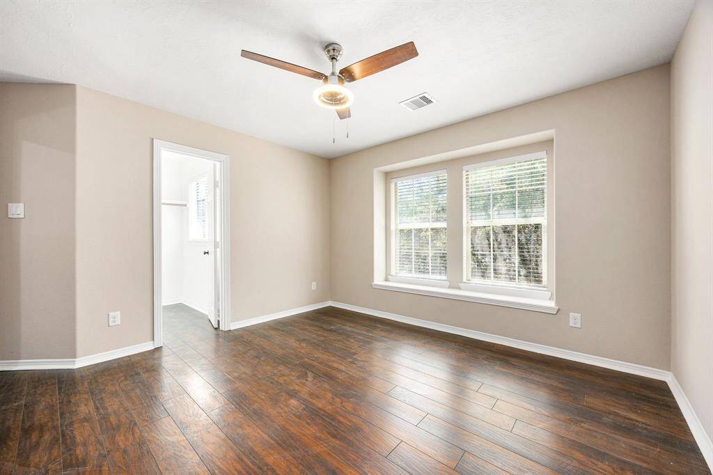 Large walk-in closet in secondary bedroom upstairs with abundant lighting and a ceiling fan.
