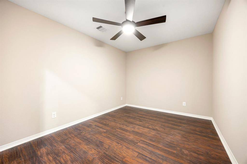 Upstairs flex space with no closet or window, ideal for use as a media room, home gym, or additional storage area.