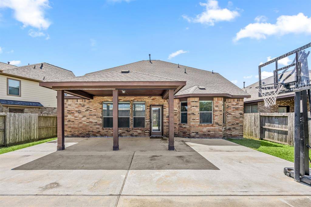 With a full brick exterior and a large covered patio, this backyard offers ample space to transform into whatever you envision.