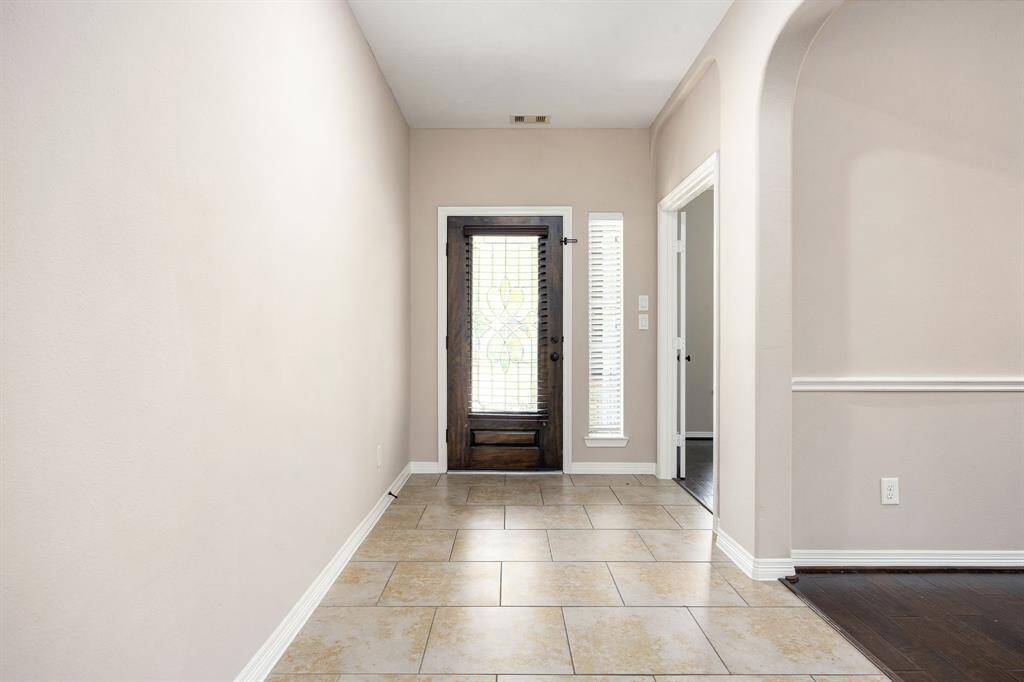 Front foyer has a defined space into the home and allows for plenty of space for your personal and decorative touches on the wall.