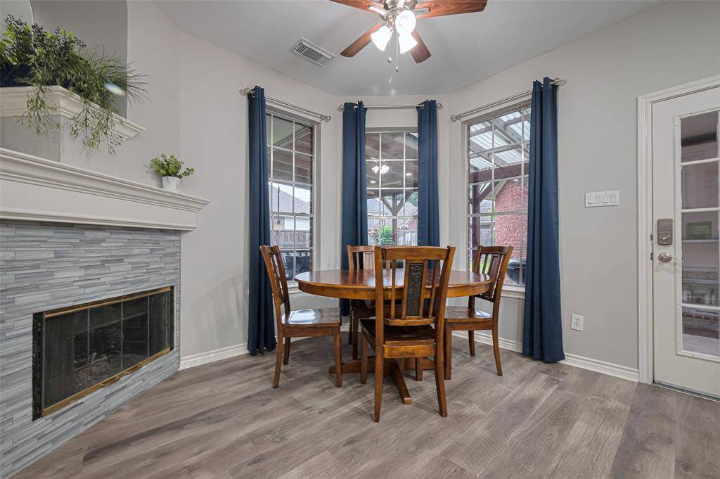 Cozy breakfast area overlooking the backyard.  Double sided fireplace adds a touch of elegance to your morning coffee.