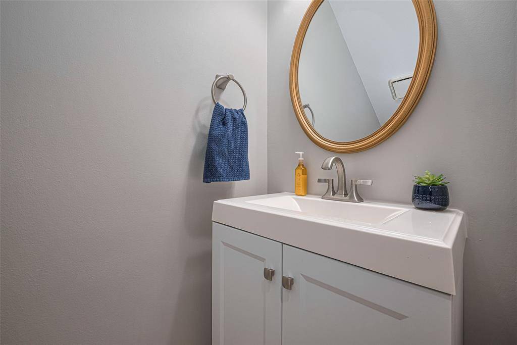 In the hallway access from kitchen to dining room is the cute half bath.