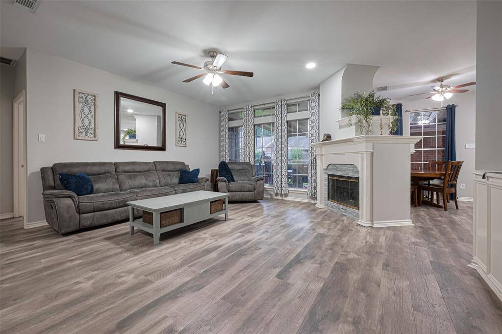 HUGE family room.   Open to the kitchen yet still a lot of wall space for TV, etc.  Lots of natural light plus recent LED recessed lights.  Fireplace  with its classic surround and built-in planter box is both sophisticated and functional.