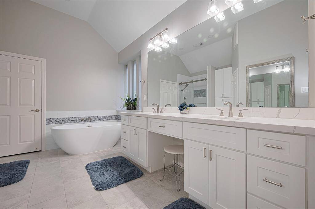 The remodeled master bath offers granite countertops with vanity area, updated lighting and fixtures, a relaxing soaking tub . . .all connected to a spacious walk-in closet for ultimate convenience.