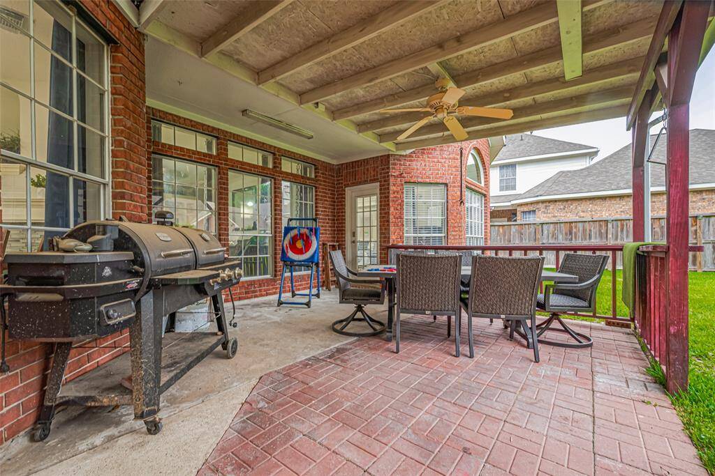 Enjoy outdoor living on the spacious, covered extended patio, perfect for entertaining with a dining area that comfortably accommodates family and guests.