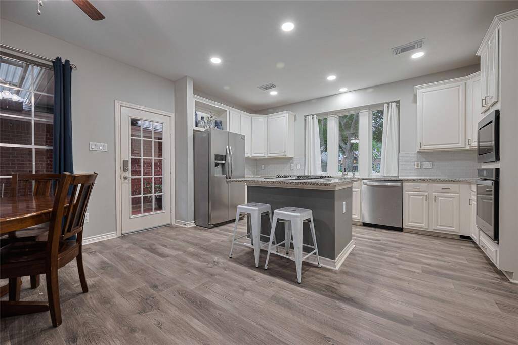 This gourmet kitchen boasts all the recent updates.  Engineered wood flooring, stainless appliances . . .