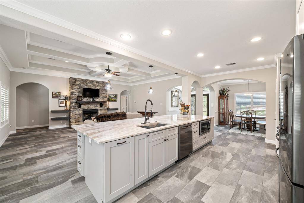 A view toward the dining area showcases plentiful cabinetry, abundant counter space, and a layout designed for everyday ease.