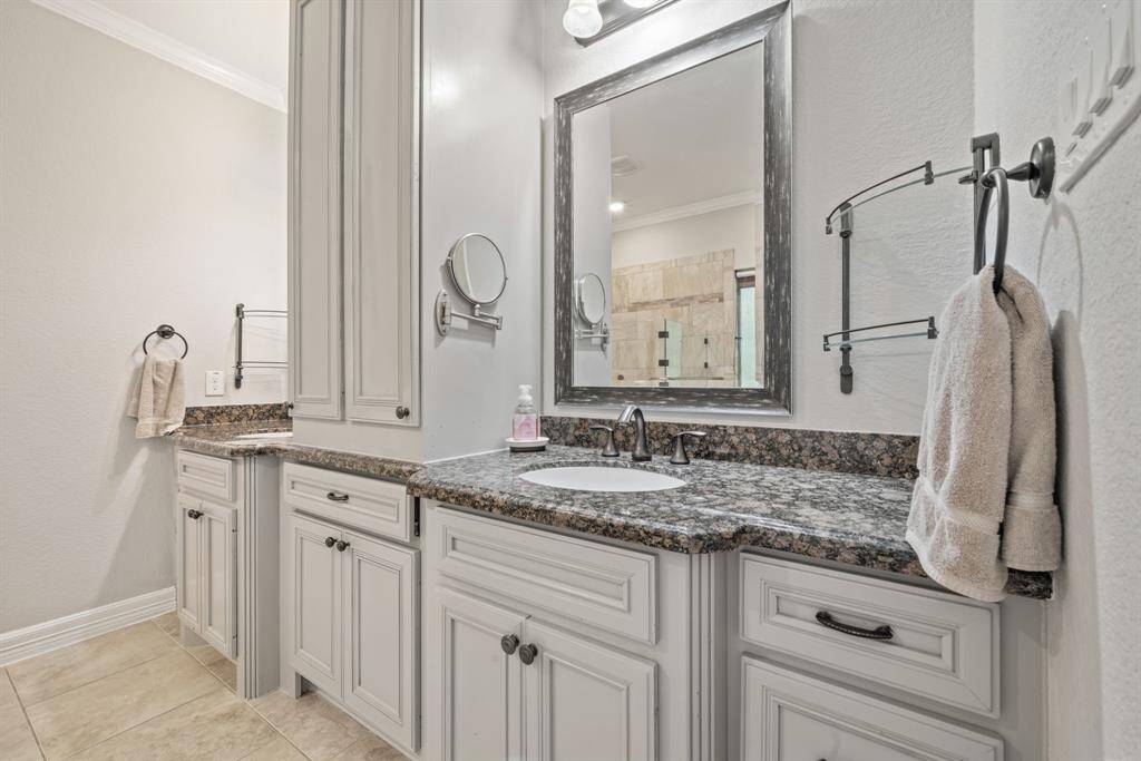 Dual vanities with ample cabinetry offer convenience and style, perfect for everyday routines or evening wind-downs.