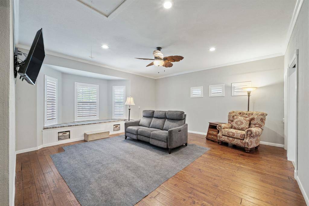 This oversized flex room exudes coziness, with built-in bench seating beneath a trio of bay windows overlooking the landscape.