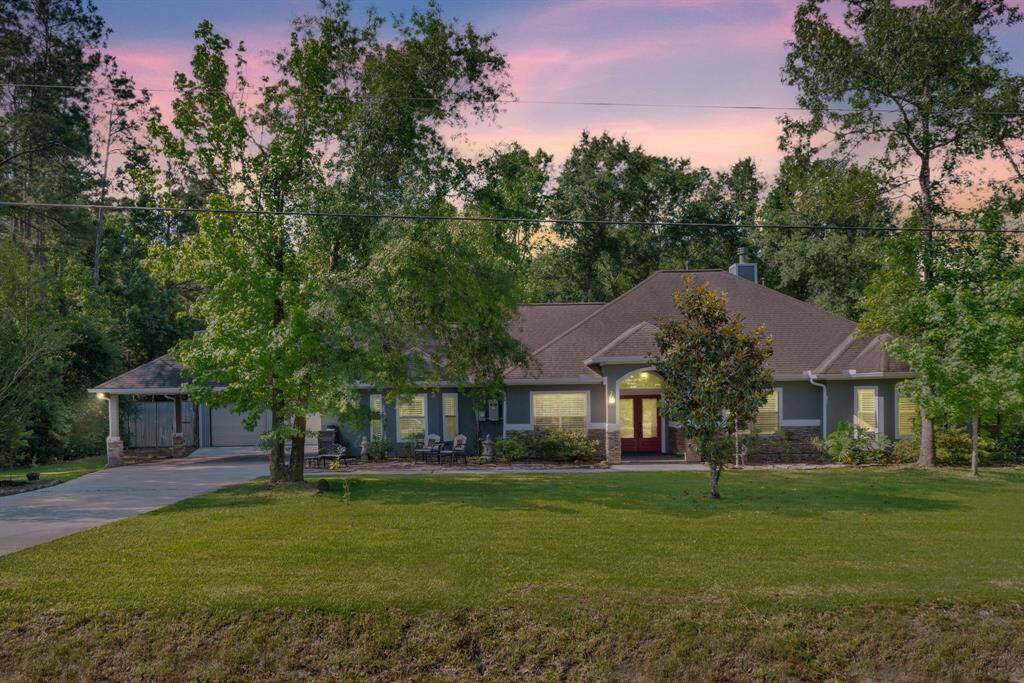 As dusk settles, the expansive front lawn glows under the soft twilight, highlighting the home’s lovely façade and peaceful setting.