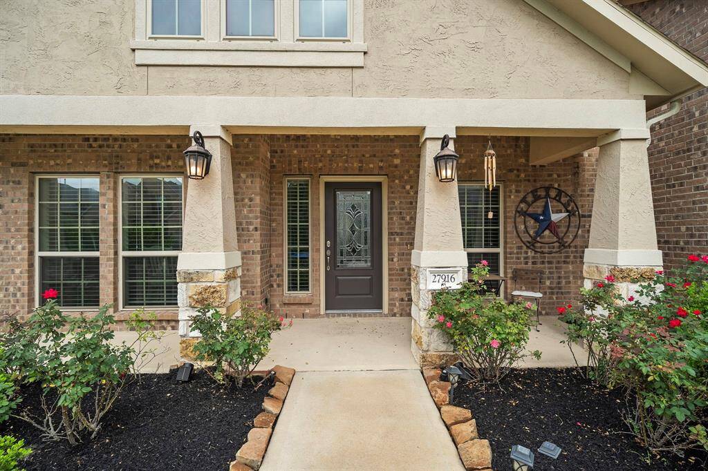 Beautiful covered front porch, perfect for relaxing after a long day or watching the kids play outside.