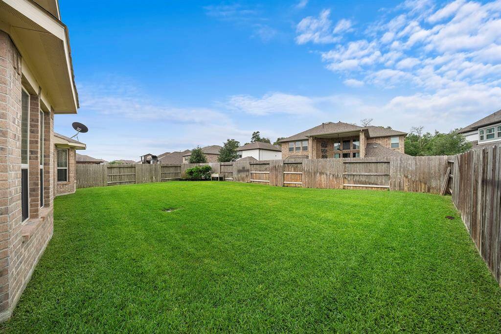 Large backyard perfect for a pool, playset, and garden.