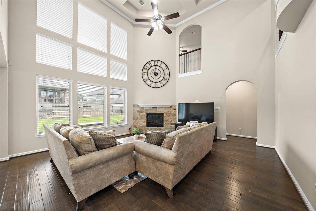 Large open living room with a wall of windows allowing for plenty of natural light to come in.