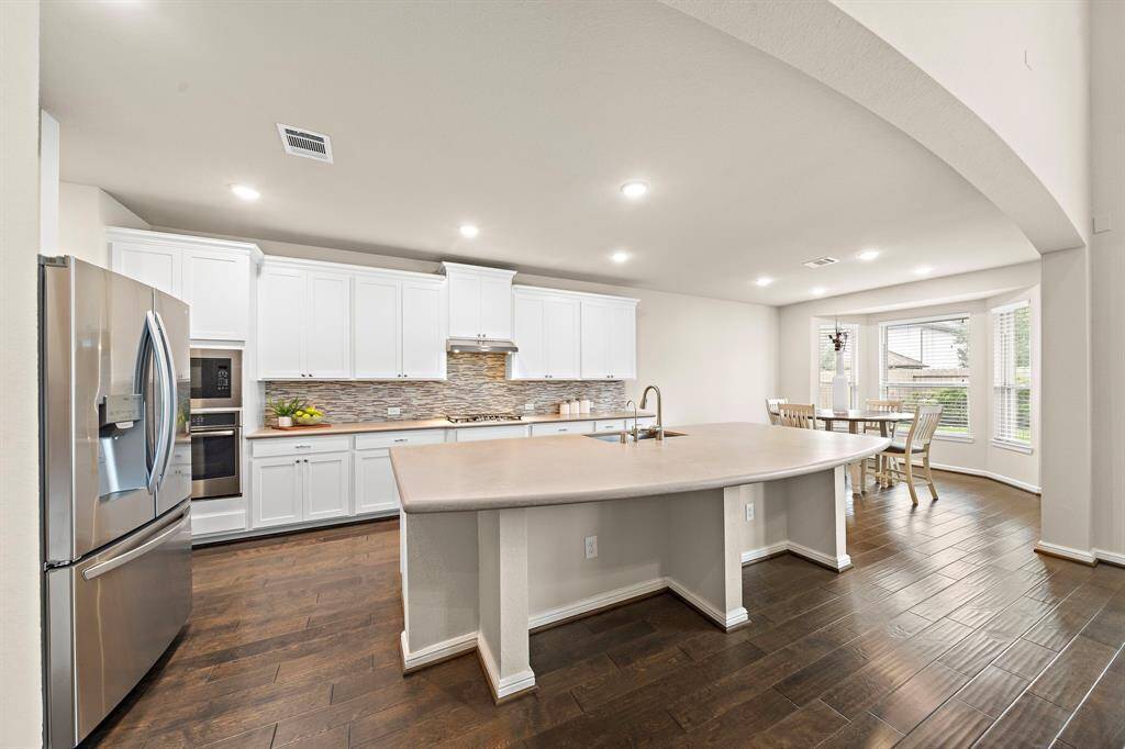 The gourmet kitchen features a breakfast bar for extra seating.
