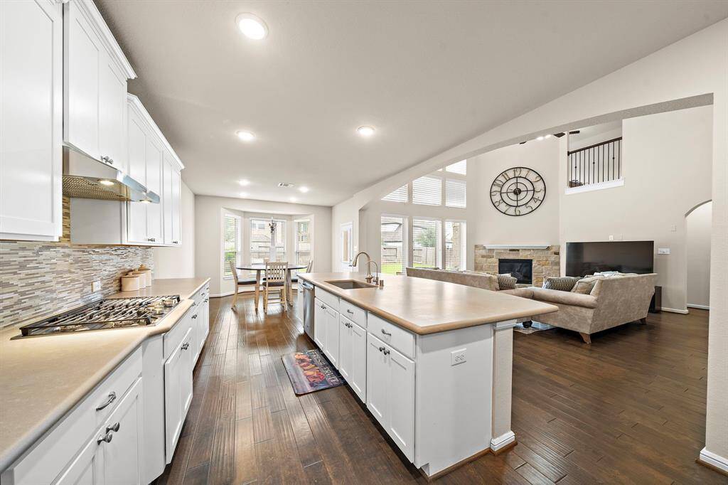 The kitchen has an oversized kitchen island feartung quartz countertops, and plenty of counter space and cabinet space for storage.