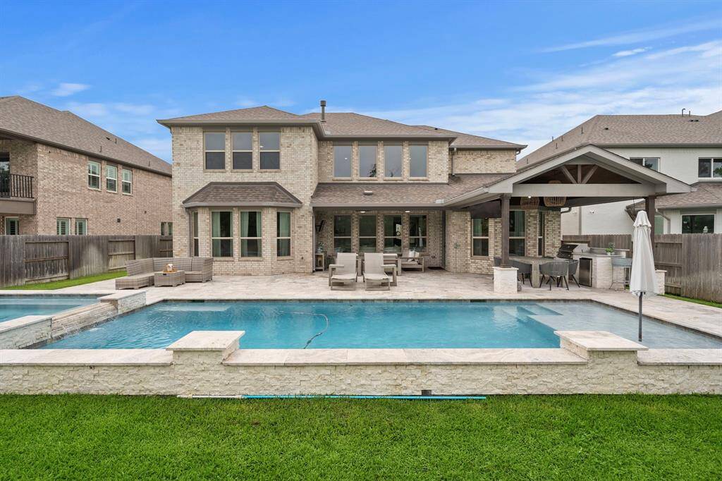 The backyard features a heated gunite pool and spa with a suntan ledge.