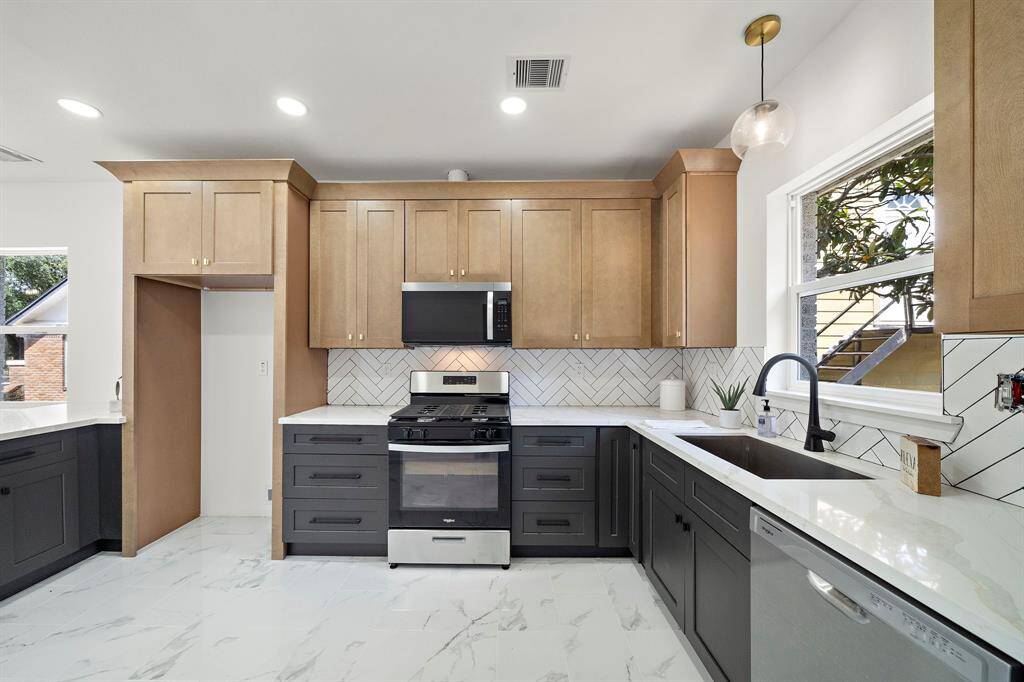 Thoughtful design with ample storage and beauty! Window above the sink offers you a view of the luscious backyard.