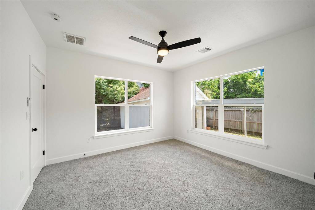 2 Large windows flood this bedroom with natural light, making this room airy
