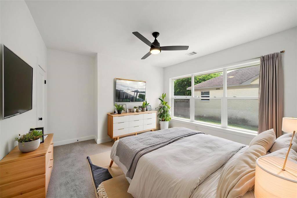 Large main level bedroom, includes modern touches.