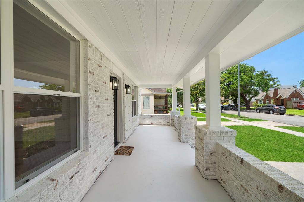This covered front porch offers the PERFECT sitting area to enjoy a glass of lemonade. Think, porch swing, on a breezy day!